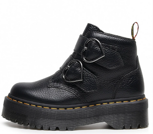 Black leather boot with heart-shaped buckles on a white background