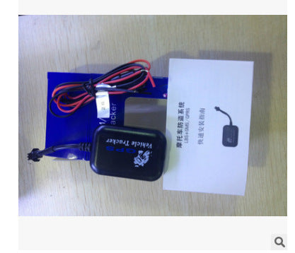 Black vehicle tracker unit with bundled wires and instruction paper