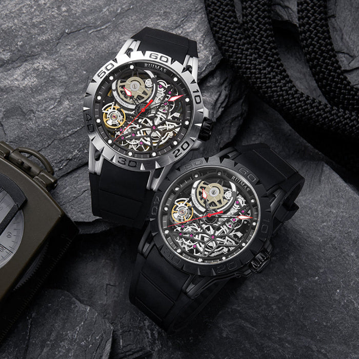 Two black wristwatches with detailed faces on a textured surface