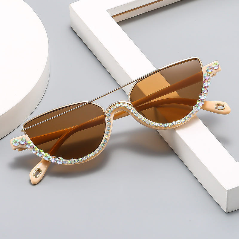 Cat-eye sunglasses with gold frame, warm amber lenses, and multicolor jeweled trim