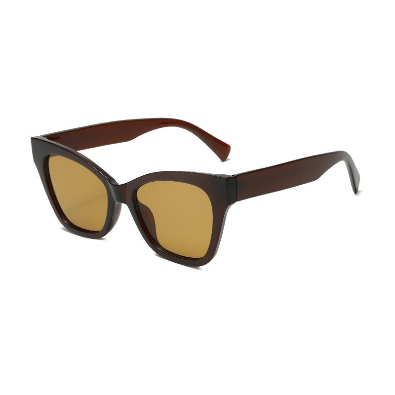 Brown sunglasses with amber-tinted lenses and angular cat-eye profile
