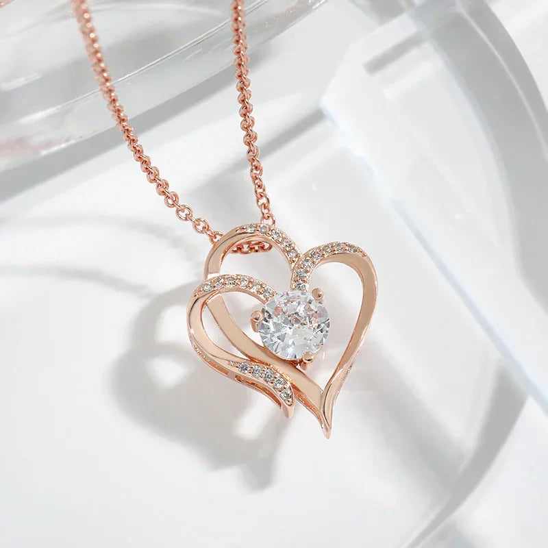 Rose gold double heart pendant necklace with a round center stone and pave accents