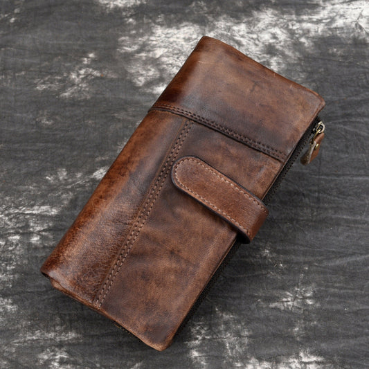 Brown leather wallet on a textured gray surface