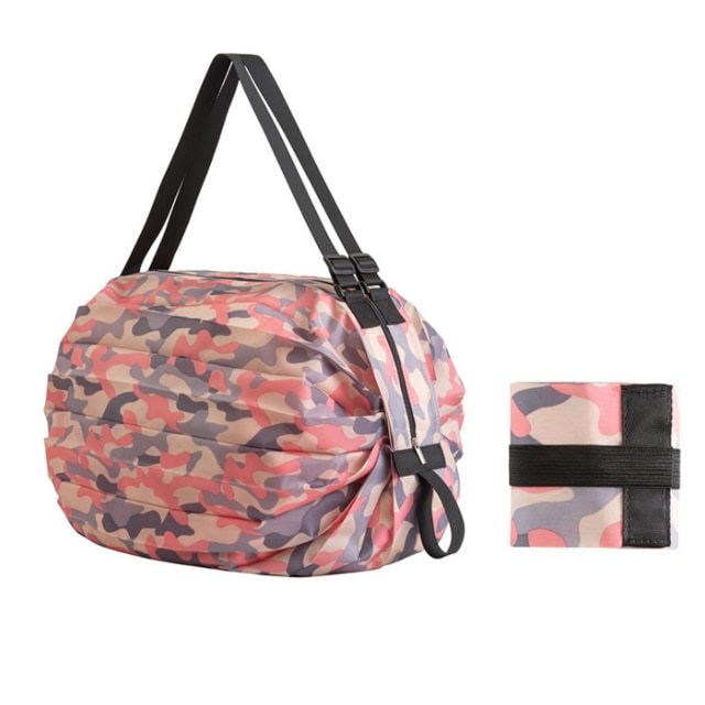 Camouflage-patterned bag with a smaller matching roll-up item on a white background