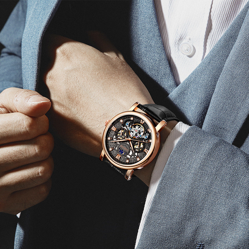 Close-up of a person wearing a rose gold watch with a dark face.