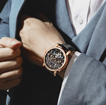 Close-up of a person wearing a rose gold watch with a dark face.