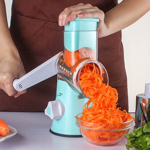 Person using a manual vegetable shredder to shred carrots into a bowl.