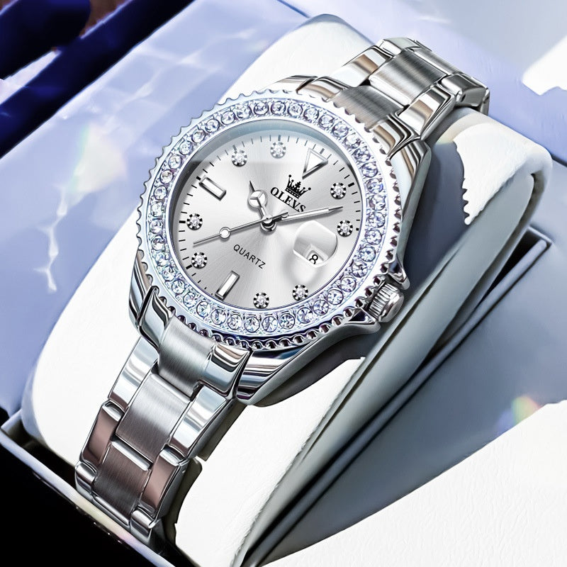 Quartz wristwatch with pale dial, crystal bezel, and silver metal link bracelet
