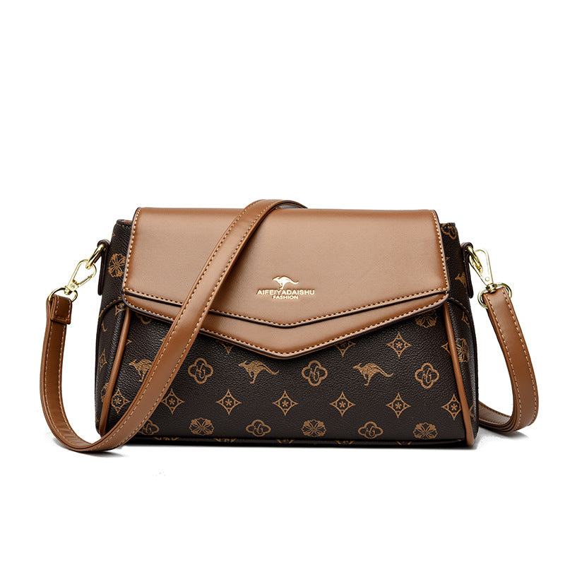 Dark brown logo crossbody shoulder bag with tan flap, gold-tone hardware, crossbody strap