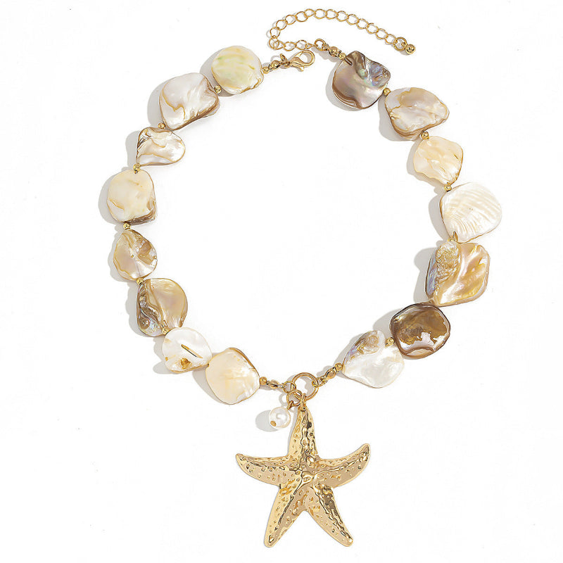 Starfish shell pendant necklace featuring cream shell disc beads and gold starfish charm