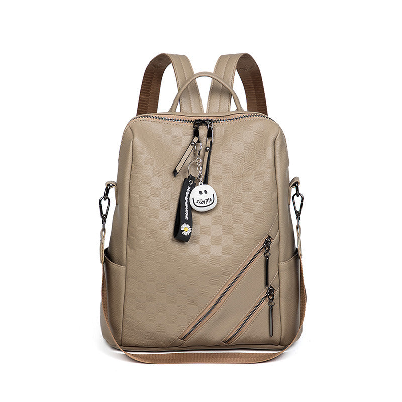 Beige backpack with brown straps on a white background