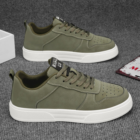 Men's green sneakers with white soles on a gray surface. YAXSO UAE