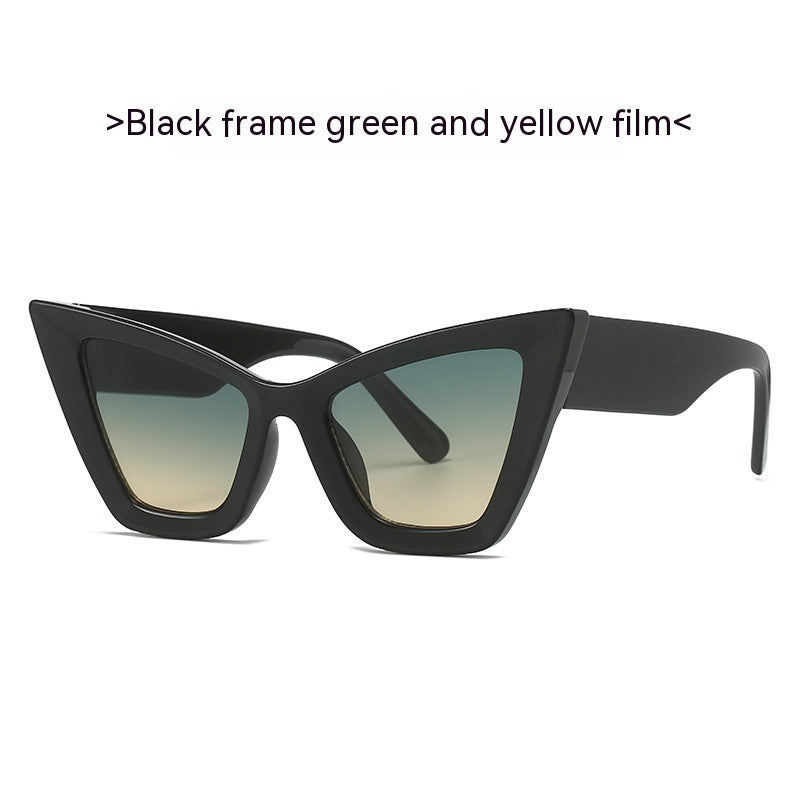 Black cat-eye sunglasses with gradient lenses in green and yellow tones