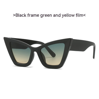 Black cat-eye sunglasses with gradient lenses in green and yellow tones