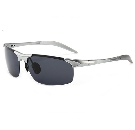 Sunglasses with silver frame and dark lenses on a white background