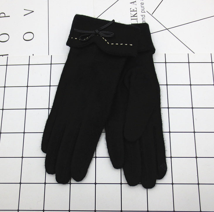 Black gloves with a bow on a grid background