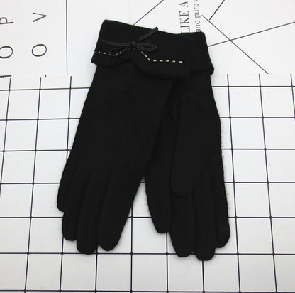 Black gloves with a bow on a grid background