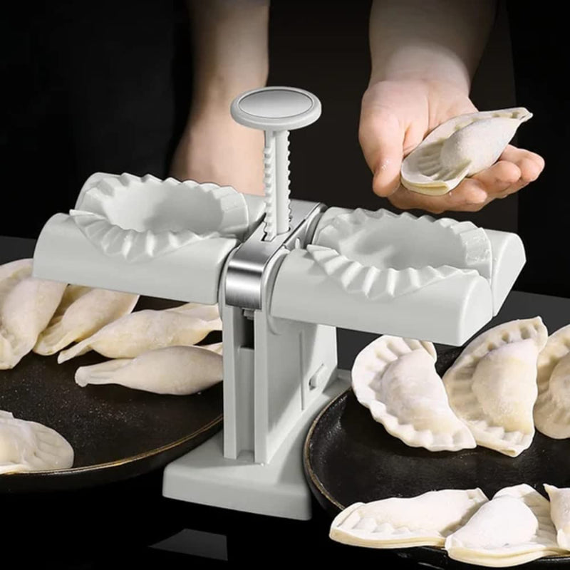 Dough press with dumplings on a dark background