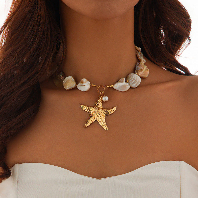 Gold-tone shell bead necklace featuring a large starfish pendant charm