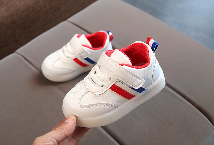 Kids white LED light-up sneakers with red heel and side stripes; glowing soles