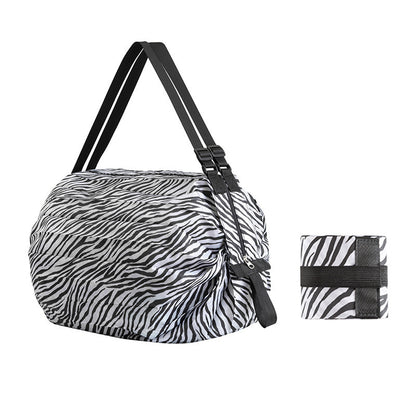 Zebra-patterned bag and matching strap on a white background