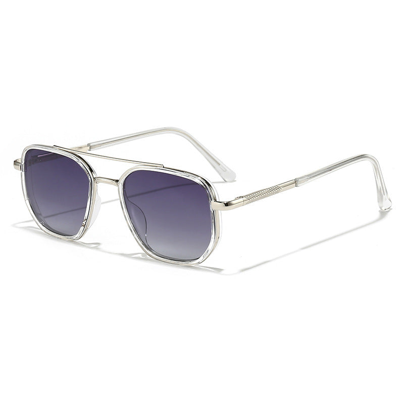Sunglasses with silver frame and dark lenses on a white background