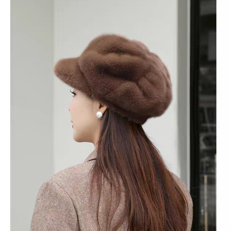 Woman wearing a brown knit cap with a plain background