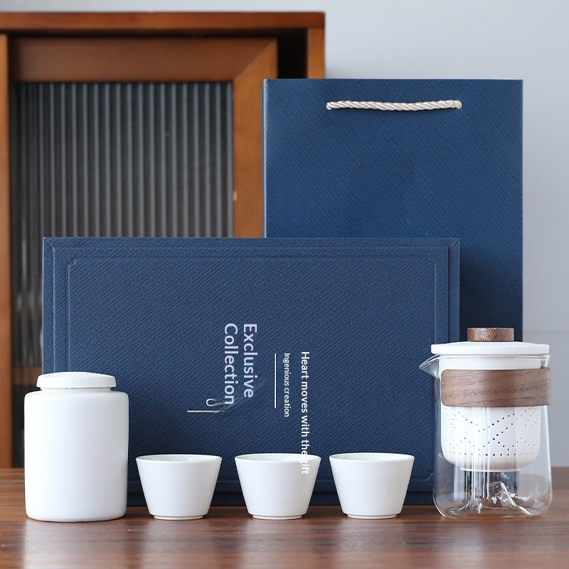 Blue office gift set with notebook, pen, tea canister, and three white tea cups
