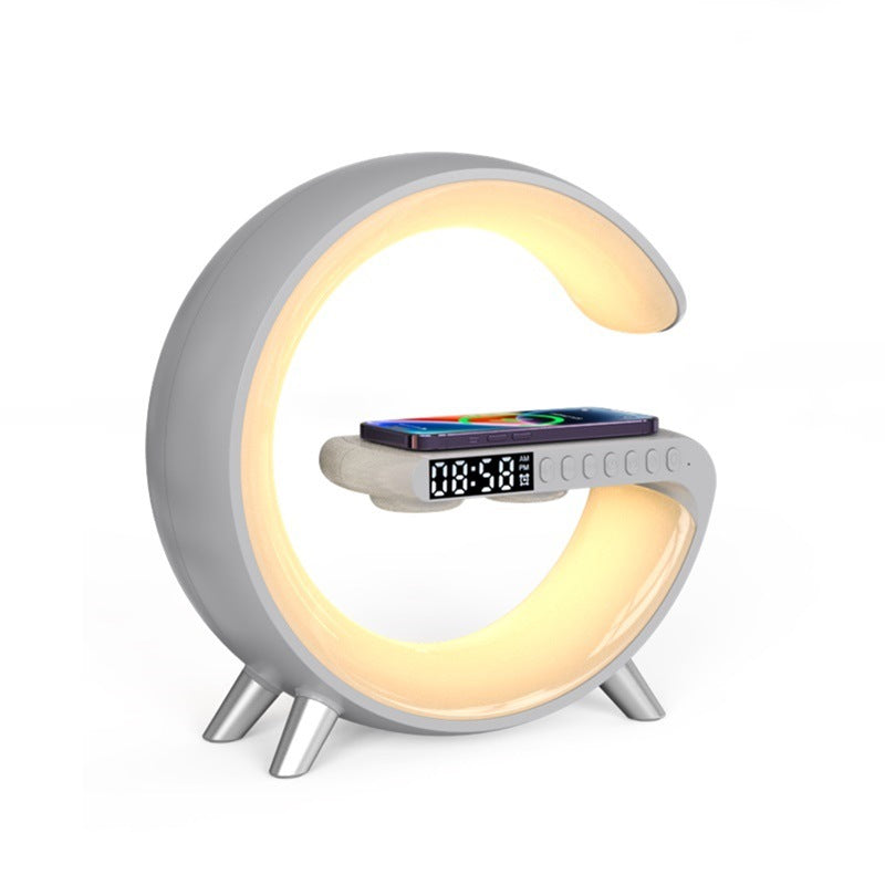 Gray G-shaped lamp with warm LED lighting, digital clock and wireless phone charging pad