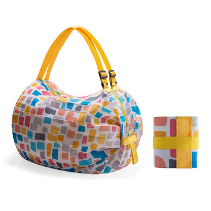 Colorful patterned bag with yellow accents and matching cylindrical container on a white background