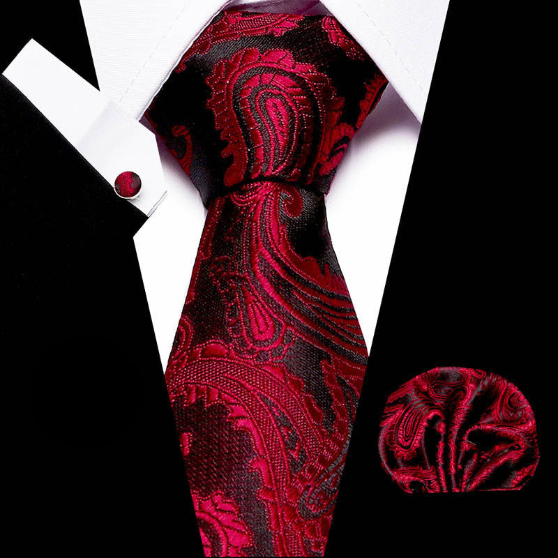 Men's business tie in burgundy red with swirling ornate paisley design