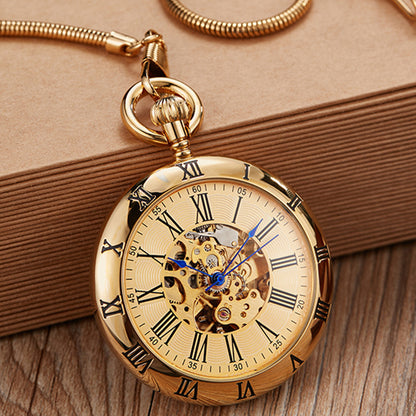 Gold pocket watch with Roman numerals on a wooden surface