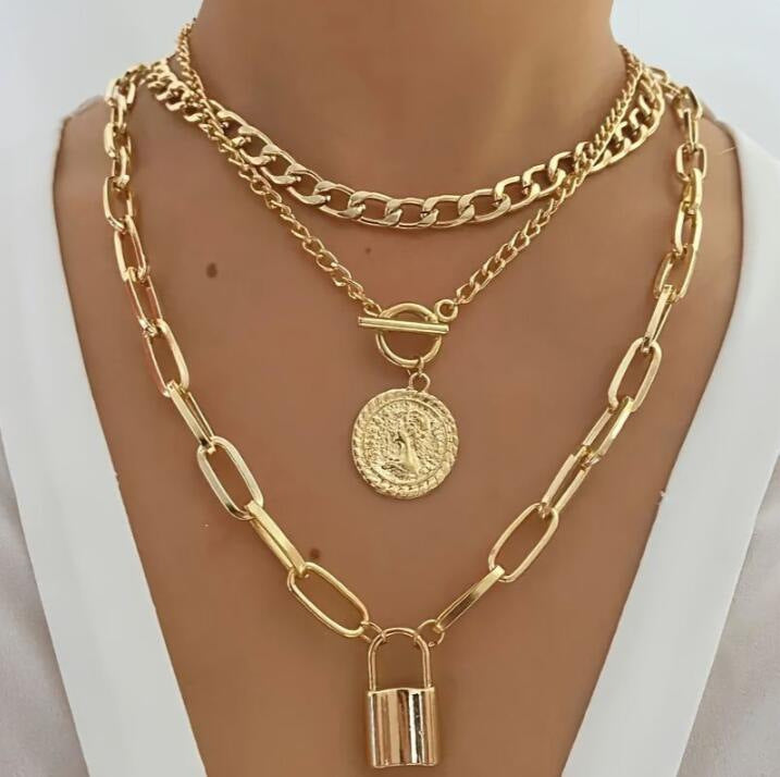 Gold-tone multi-layer chain necklace set with round medallion, loop charm, padlock pendant
