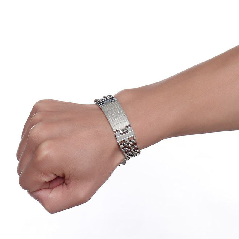 Silver bracelet on a wrist against a white background