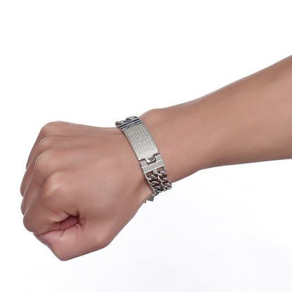 Silver bracelet on a wrist against a white background