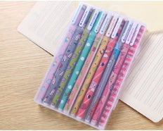 Set of colorful markers in a transparent case on a wooden surface