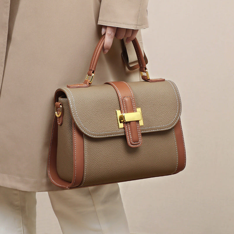 Women’s leather handbag with top handles, camel flap front, contrast brown edge trim, gold clasp