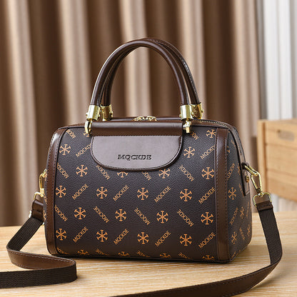 Brown handbag with gold patterns on a wooden surface