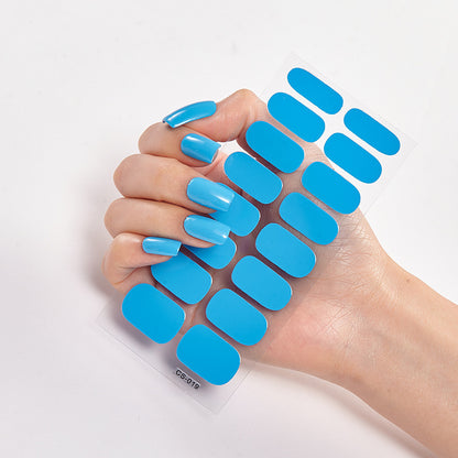 Hand holding blue nail extensions on a white background