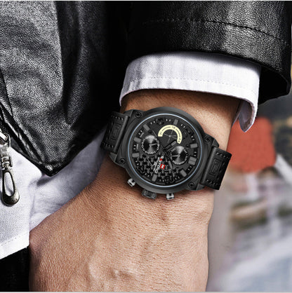 Black wristwatch on a person's wrist with a blurred background