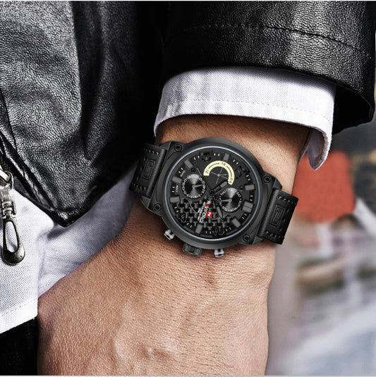 Black wristwatch on a person's wrist with a blurred background