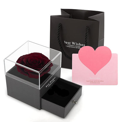 Acrylic jewelry gift box with dark red rose centerpiece and pink heart card, open