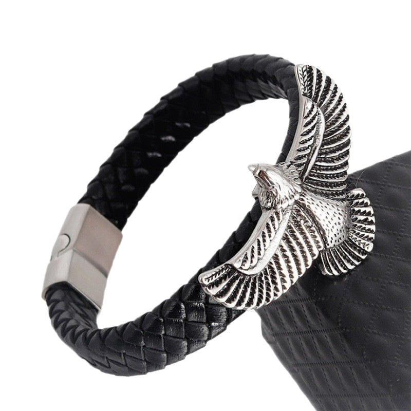 Close-up black braided leather bracelet with silver eagle head and wing details