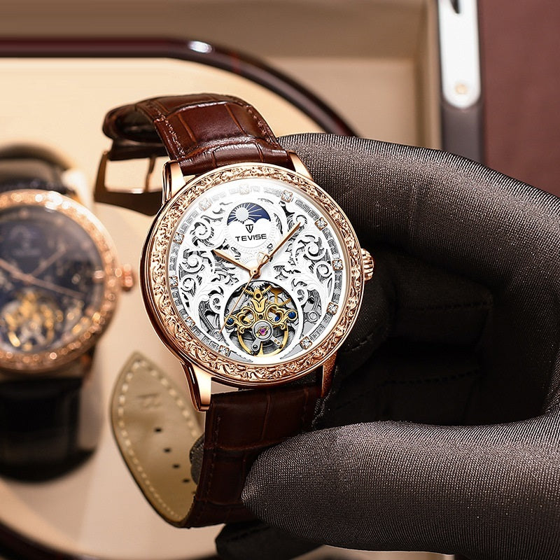 Rose-gold mechanical skeleton watch with brown leather strap, angled side view