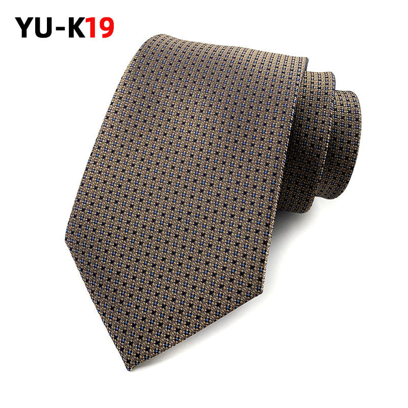 Brown patterned tie on a white background with 'YU-K19' branding.
