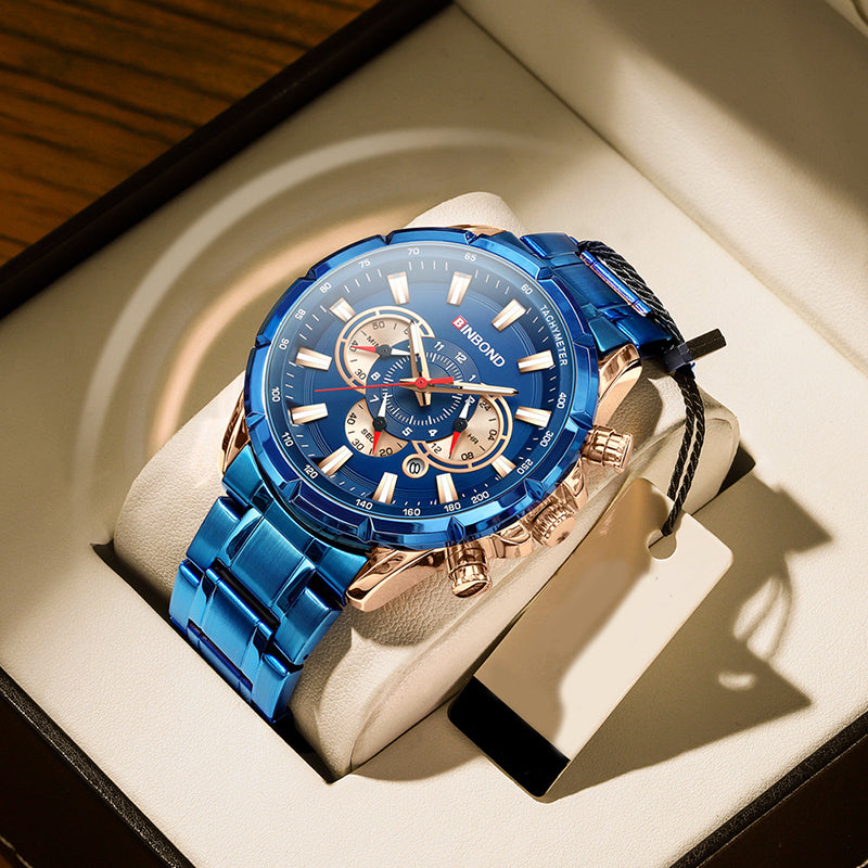 Blue dial tactical wristwatch with gold bezel and blue metal bracelet on cushion