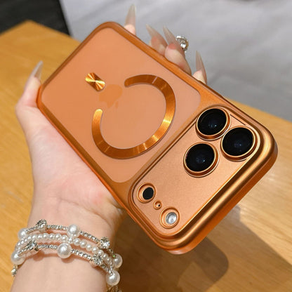 Person holding a gold phone case with a unique design on a wooden surface