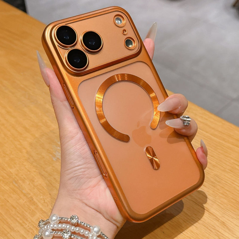 Hand holding a gold phone case with a clear back on a wooden surface