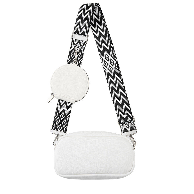 White faux-leather crossbody bag with adjustable strap, front pocket, round mini pouch