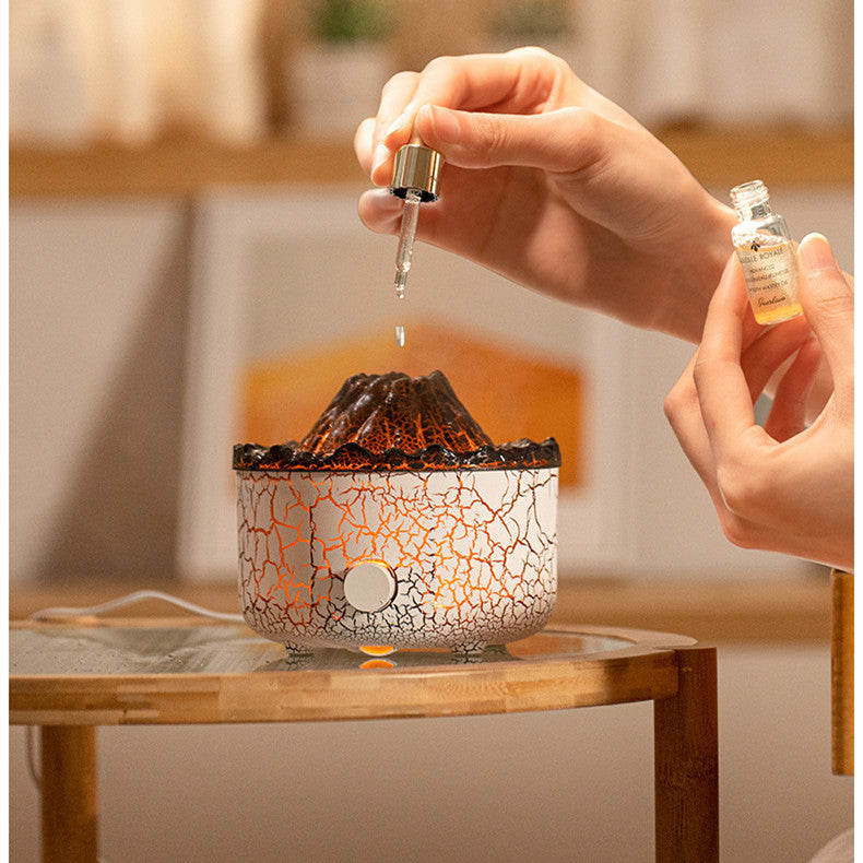 Person pouring a liquid into a cracked-patterned lamp on a wooden table.